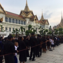 Thai people lining up in front of the Grand Palace to mourn their King